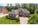 A brick home with dark shutters, a well-manicured lawn, and a curved driveway adds to the curb appeal at 4409 Winder Trl, Gastonia, NC 28056