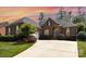Brick home with a curved driveway, beautiful landscaping, and an attached garage creates a welcoming entrance at 4409 Winder Trl, Gastonia, NC 28056