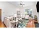 Bright living room boasts hardwood floors, a neutral color scheme, and large windows at 4409 Winder Trl, Gastonia, NC 28056