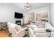 Open-concept living room featuring hardwood floors, a cozy fireplace, and abundant seating at 4409 Winder Trl, Gastonia, NC 28056