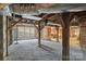 Unfinished basement has exposed brick columns, wood beams, gravel floor, and windows for natural light at 448 Union S St, Concord, NC 28025