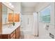 A bright bathroom features a vanity with ample storage and a shower-tub combo at 448 Union S St, Concord, NC 28025