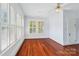 Sunny bedroom with hardwood floors and large windows with classic shutters for natural light at 448 Union S St, Concord, NC 28025