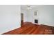 Light-filled bedroom showcases hardwood floors and a charming fireplace with classic white trim at 448 Union S St, Concord, NC 28025