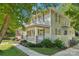 Classic two-story home with a welcoming porch, well-maintained landscaping, and mature trees providing shade at 448 Union S St, Concord, NC 28025