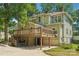 Exterior rear view of house with a wooden deck and a partially covered area at 448 Union S St, Concord, NC 28025