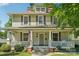 Charming two-story home featuring a welcoming front porch, classic shutters, and a well-maintained lawn at 448 Union S St, Concord, NC 28025