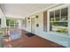Inviting front porch with wood flooring, decorative columns, and stylish lighting fixtures, creating a cozy entrance at 448 Union S St, Concord, NC 28025