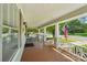 Charming front porch with wooden floors, white railings, and a swing, perfect for relaxing and enjoying the outdoors at 448 Union S St, Concord, NC 28025