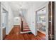 A bright hallway features stairs with wooden banisters and a view into the dining room at 448 Union S St, Concord, NC 28025