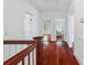 This upstairs hallway features a wooden banister and views into the bedrooms and living spaces at 448 Union S St, Concord, NC 28025