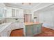 Well-lit kitchen featuring an island with seating and ample counter space at 448 Union S St, Concord, NC 28025