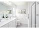 Well-lit bathroom featuring a double vanity, modern fixtures, and a glass-enclosed shower, offering a spa-like experience at 490 Lenswood Ct, Denver, NC 28037