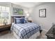 Cozy bedroom featuring a plaid comforter, sports-themed decor, and warm lighting creating a welcoming atmosphere at 490 Lenswood Ct, Denver, NC 28037