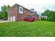 Large backyard with brick home exterior and attached garage at 5004 Woodview Ln, Matthews, NC 28104