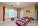 Fun bedroom with a race car bed and natural light at 5004 Woodview Ln, Matthews, NC 28104