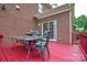 View of deck with outdoor furniture, a grill, and a sliding glass door on a brick home at 5004 Woodview Ln, Matthews, NC 28104