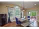Cozy dining area with backyard views, featuring a modern table with bench seating and a beverage cooler at 5004 Woodview Ln, Matthews, NC 28104