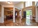 Grand foyer featuring marble floors and elegant columns leading to the dining room at 5004 Woodview Ln, Matthews, NC 28104