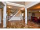Grand foyer boasting hardwood floors, staircase, and architectural columns that accent this inviting space at 5004 Woodview Ln, Matthews, NC 28104