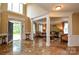 Open foyer featuring marble flooring, elegant columns, and a view of the living room at 5004 Woodview Ln, Matthews, NC 28104