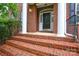 Elegant front door with brick steps and white columns, creating a welcoming entrance at 5004 Woodview Ln, Matthews, NC 28104