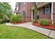 A beautifully landscaped walkway with colorful mulch leading to a brick home at 5004 Woodview Ln, Matthews, NC 28104