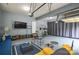 Finished garage includes seating area, TV, work out area, and epoxy floors at 5004 Woodview Ln, Matthews, NC 28104