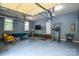 Finished garage featuring a seating area, TV, workout area, and painted blue at 5004 Woodview Ln, Matthews, NC 28104