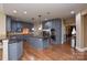 Beautiful kitchen featuring a center island, stainless steel appliances, custom cabinets, and hardwood floors at 5004 Woodview Ln, Matthews, NC 28104