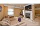 Comfortable living room with a fireplace, TV, and a cozy hanging chair at 5004 Woodview Ln, Matthews, NC 28104