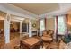 Elegant living room with decorative columns, hardwood floors, and natural light at 5004 Woodview Ln, Matthews, NC 28104