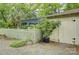 Secluded backyard featuring a light colored shed, picket fence, and lush foliage at 504 S Hayne St, Monroe, NC 28112