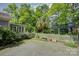 Private backyard featuring a gravel area, mature trees, and a charming fence at 504 S Hayne St, Monroe, NC 28112