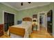 Charming bedroom with hardwood floors, and a beautiful wooden bed frame with lace trim at 504 S Hayne St, Monroe, NC 28112