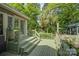 Exterior view of deck overlooking a secluded yard with abundant foliage and trees at 504 S Hayne St, Monroe, NC 28112