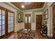 Inviting entryway with wood-paneled walls, doors, and vintage furniture accents at 504 S Hayne St, Monroe, NC 28112