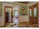 Inviting entryway with wood-paneled walls, doors, and view to the living room at 504 S Hayne St, Monroe, NC 28112