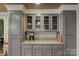 Kitchen featuring custom grey cabinets with granite countertops and glass fronts at 504 S Hayne St, Monroe, NC 28112