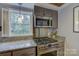 Well-equipped kitchen with granite countertops, stainless steel appliances, and lots of natural light at 504 S Hayne St, Monroe, NC 28112