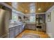 Modern kitchen with stainless steel appliances, granite countertops, and a wood ceiling at 504 S Hayne St, Monroe, NC 28112