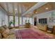Sunlit living room featuring a wood ceiling, hardwood floors, and large windows at 504 S Hayne St, Monroe, NC 28112