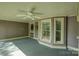 Inviting covered porch with painted wood floors, ceiling fan, and charming architectural details at 504 S Hayne St, Monroe, NC 28112