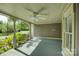 Inviting covered porch with painted wood floors, ceiling fan, and view of the garden at 504 S Hayne St, Monroe, NC 28112