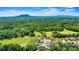 Scenic aerial view of a residential neighborhood with lush greenery and mountain views at 5163 Meadow Park Ln, Hickory, NC 28602