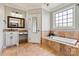Bathroom showcasing a soaking tub with tile surround, granite countertop, and classic fixtures at 5163 Meadow Park Ln, Hickory, NC 28602