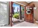 Warm welcome through a double wooden door, showcasing a glimpse of the manicured front yard at 5163 Meadow Park Ln, Hickory, NC 28602
