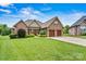 Charming brick home with lush green lawn, double garage and landscaped front, under a blue sky at 5163 Meadow Park Ln, Hickory, NC 28602