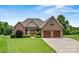 Beautiful brick home featuring a two-car garage, manicured lawn, and charming front yard landscaping at 5163 Meadow Park Ln, Hickory, NC 28602