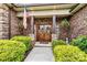 Inviting front entrance with double doors, an American flag, and beautiful landscaping at 5163 Meadow Park Ln, Hickory, NC 28602